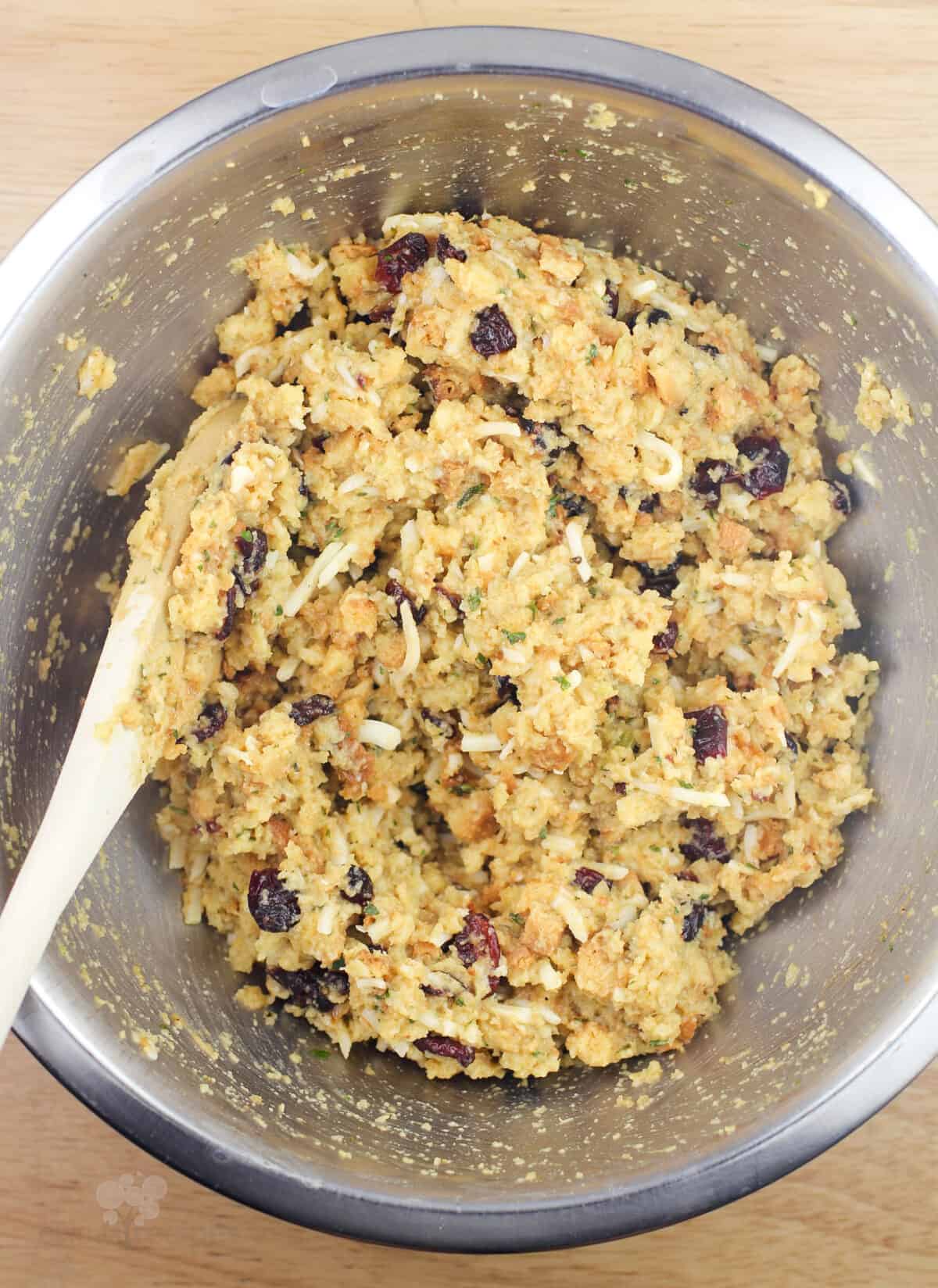 stuffing in metal bowl with wood spoon