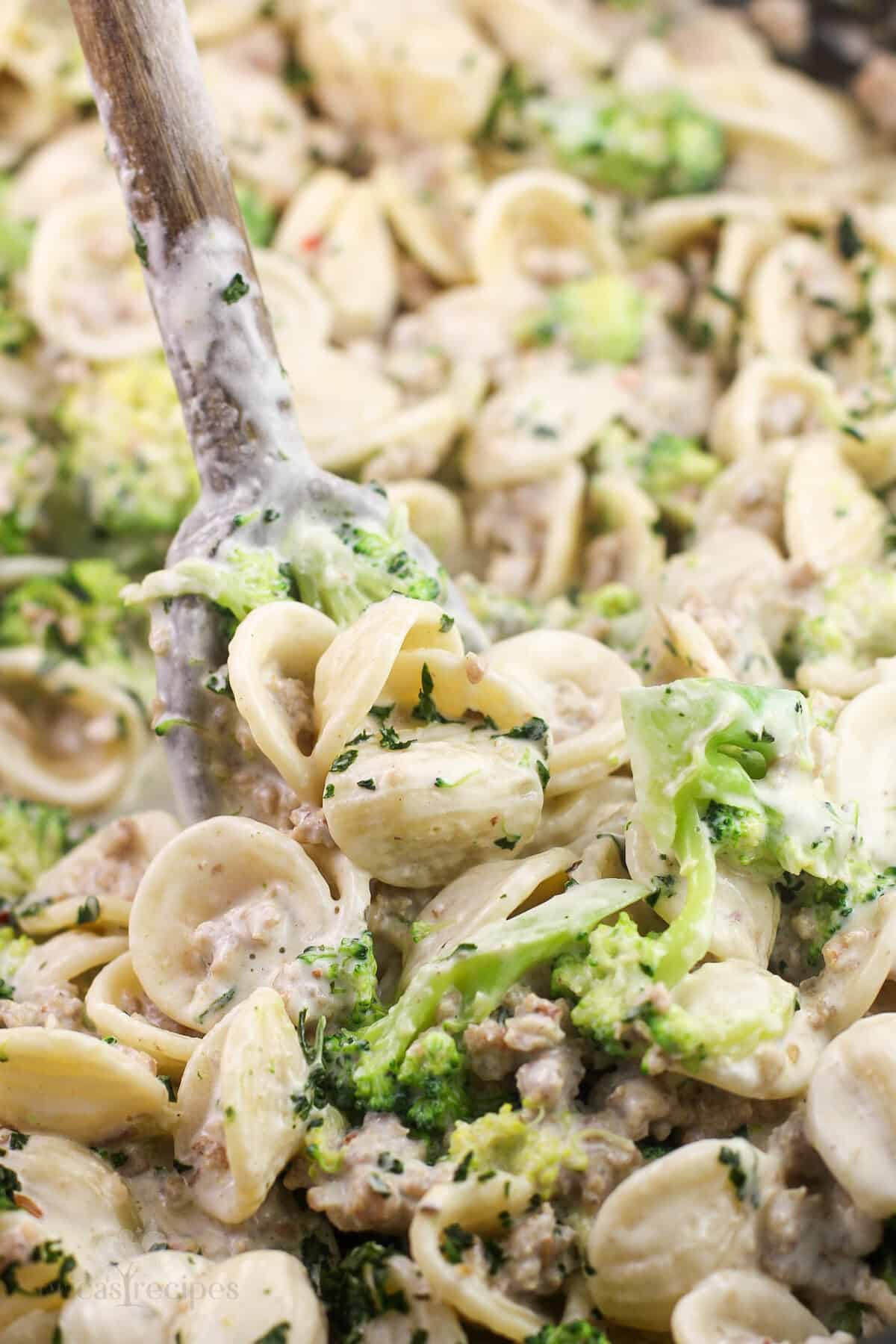 wood spoon in pasta with broccoli and sausage