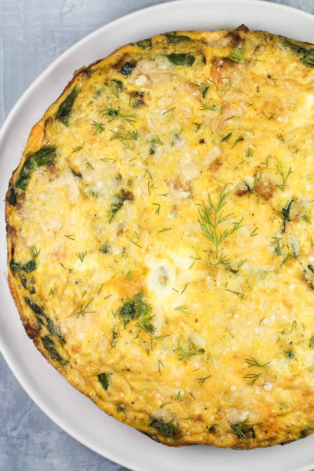 cooked whole frittata on white plate