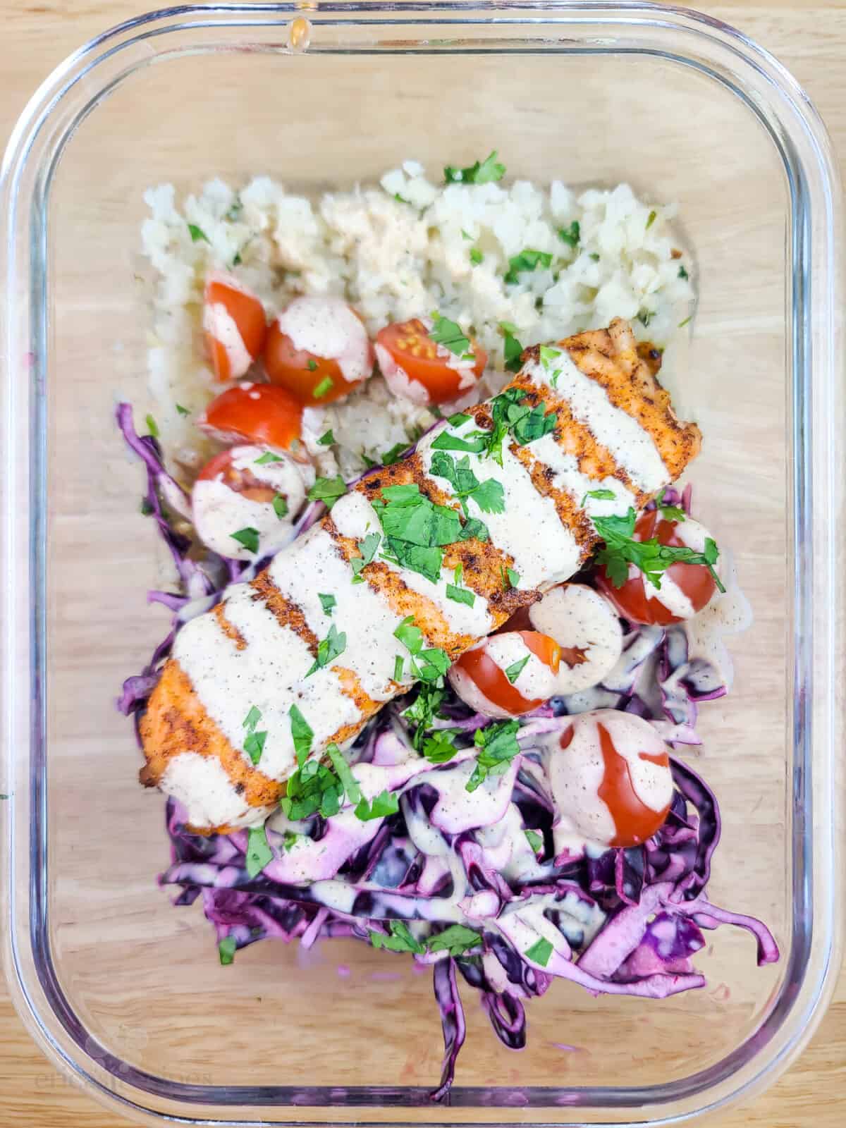 prepared salmon with veggies in glass dish