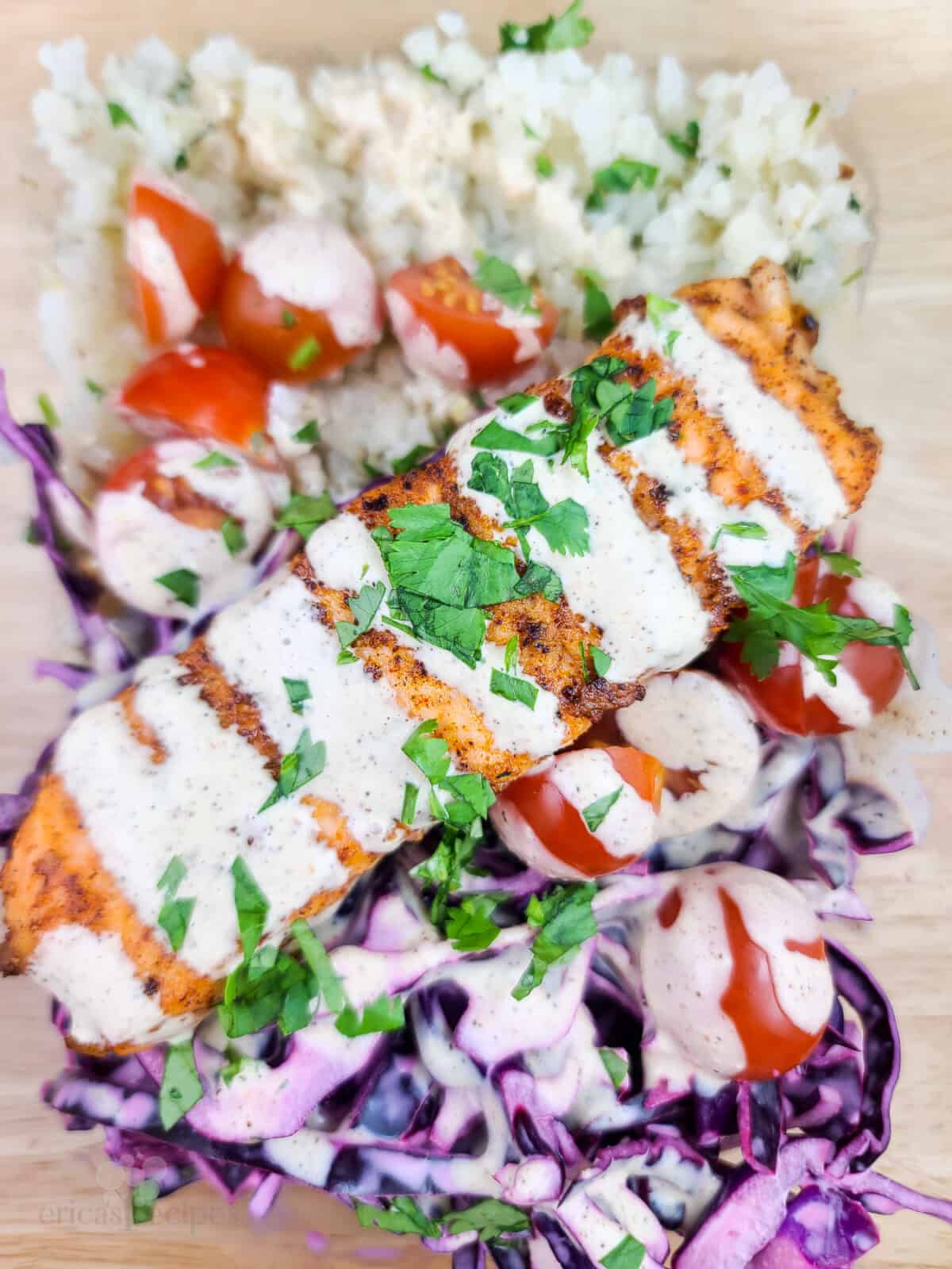 prepared meal prep salmon with veggies in glass dish