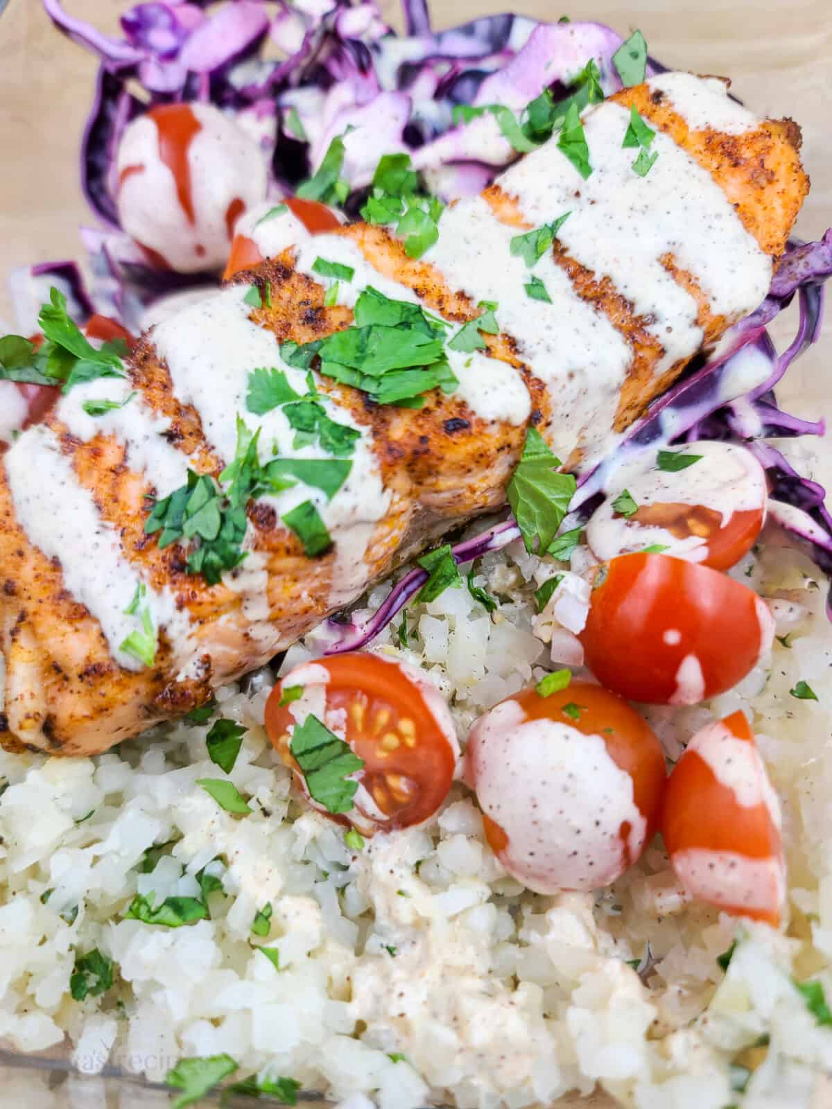cauliflower rice topped with cherry tomatoes and creamy chipotle dressing