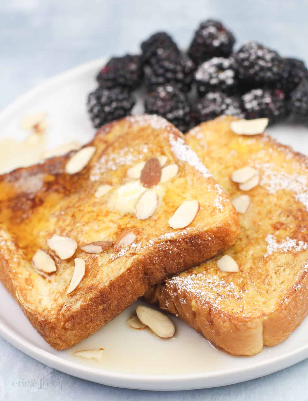 amaretto French toast on white plate with blackberries