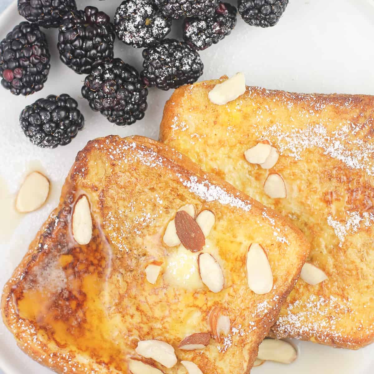 prepared recipe on white plate with blackberries