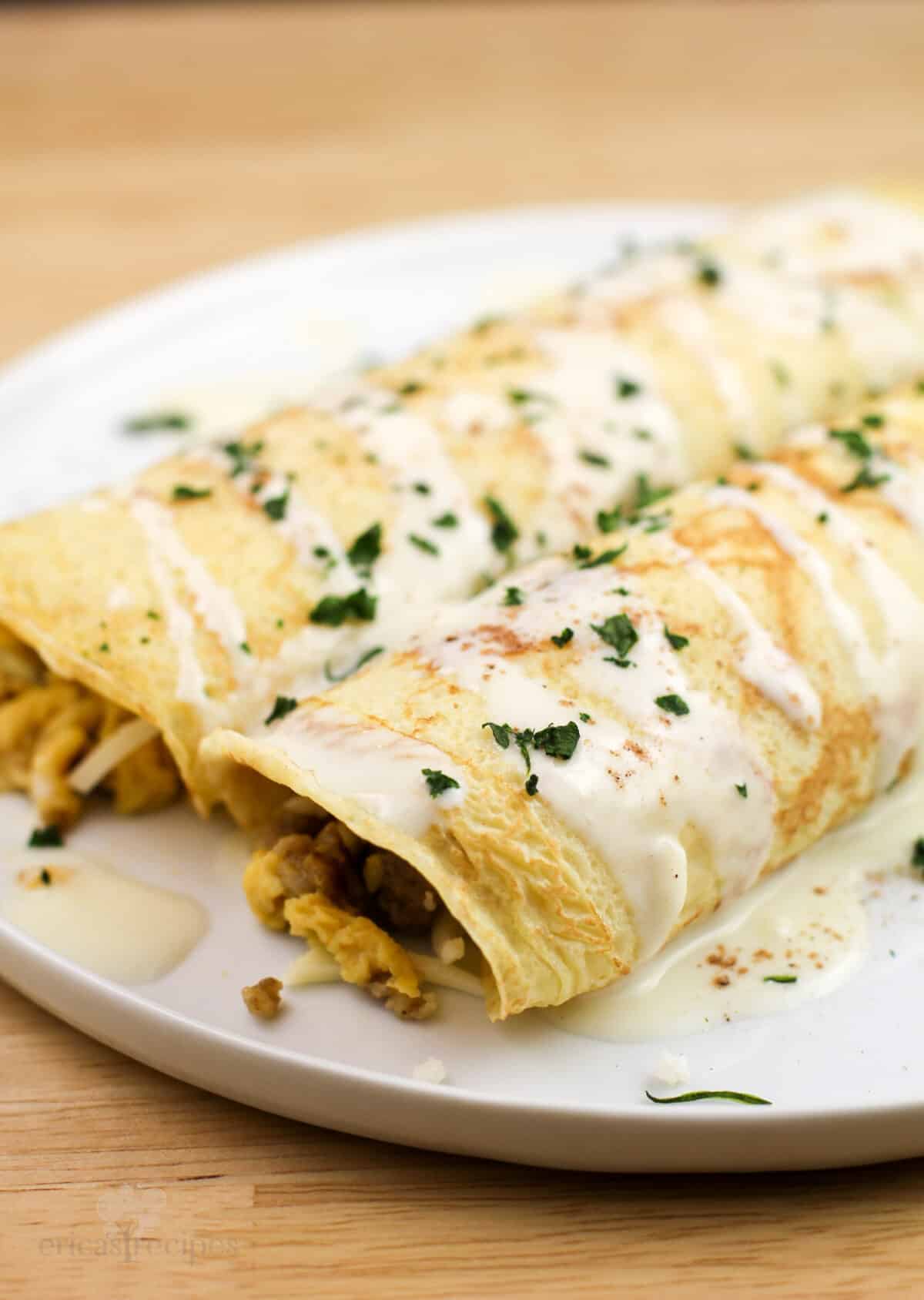 two assembled crepes on white plate