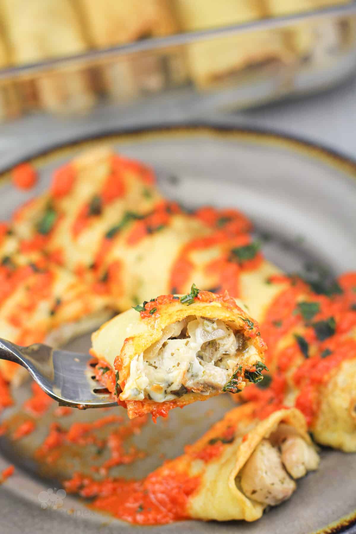 fork holding bite of crepe to show filling
