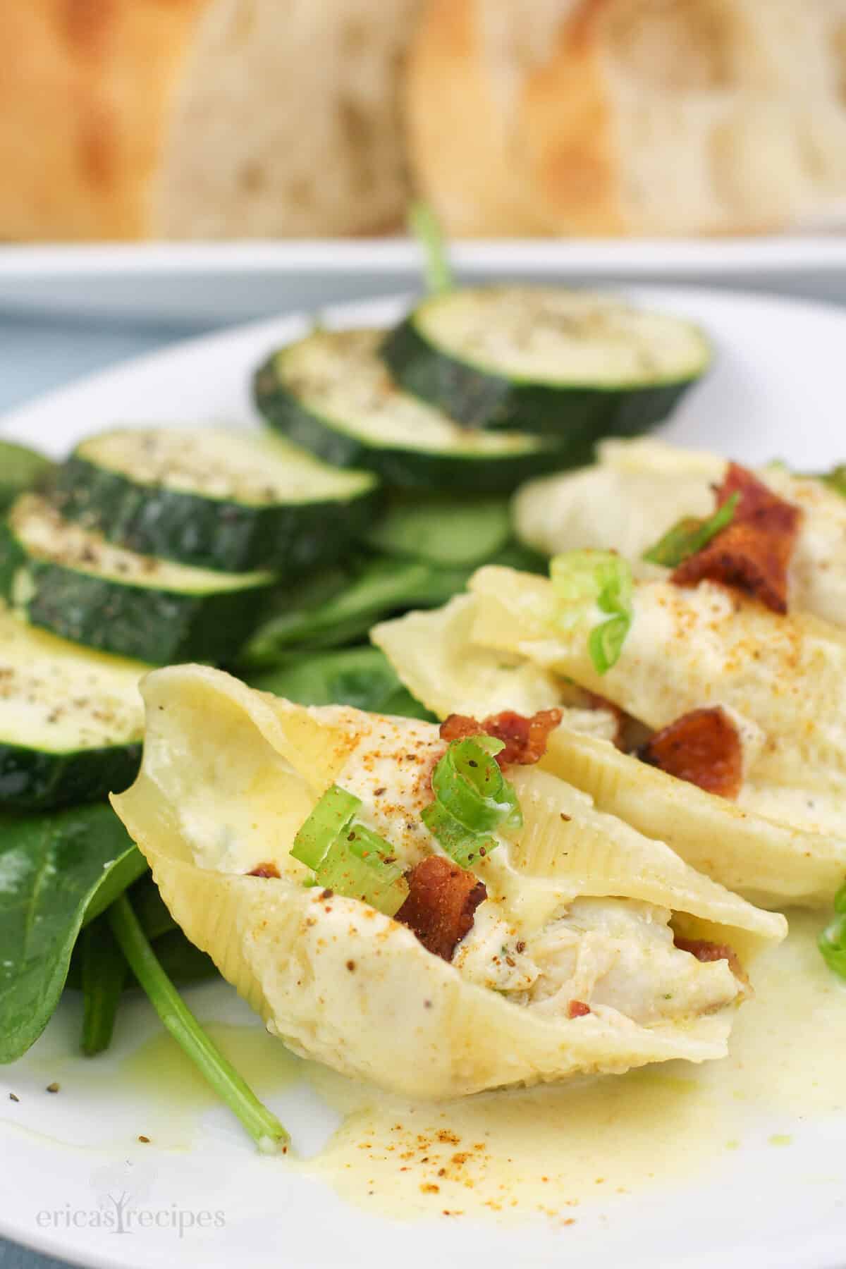 stuffed shells with crab meat on white plate with salad