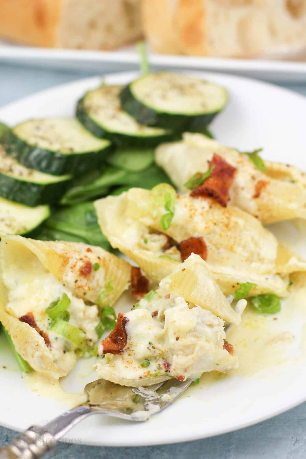 fork holding bite of prepared stuffed shells
