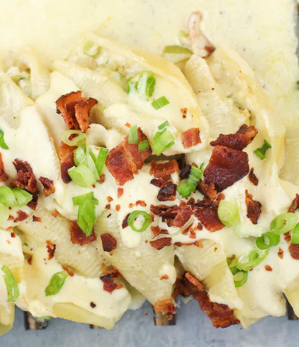 prepared recipe in bake dish, fresh from the oven topped with green onion and bacon
