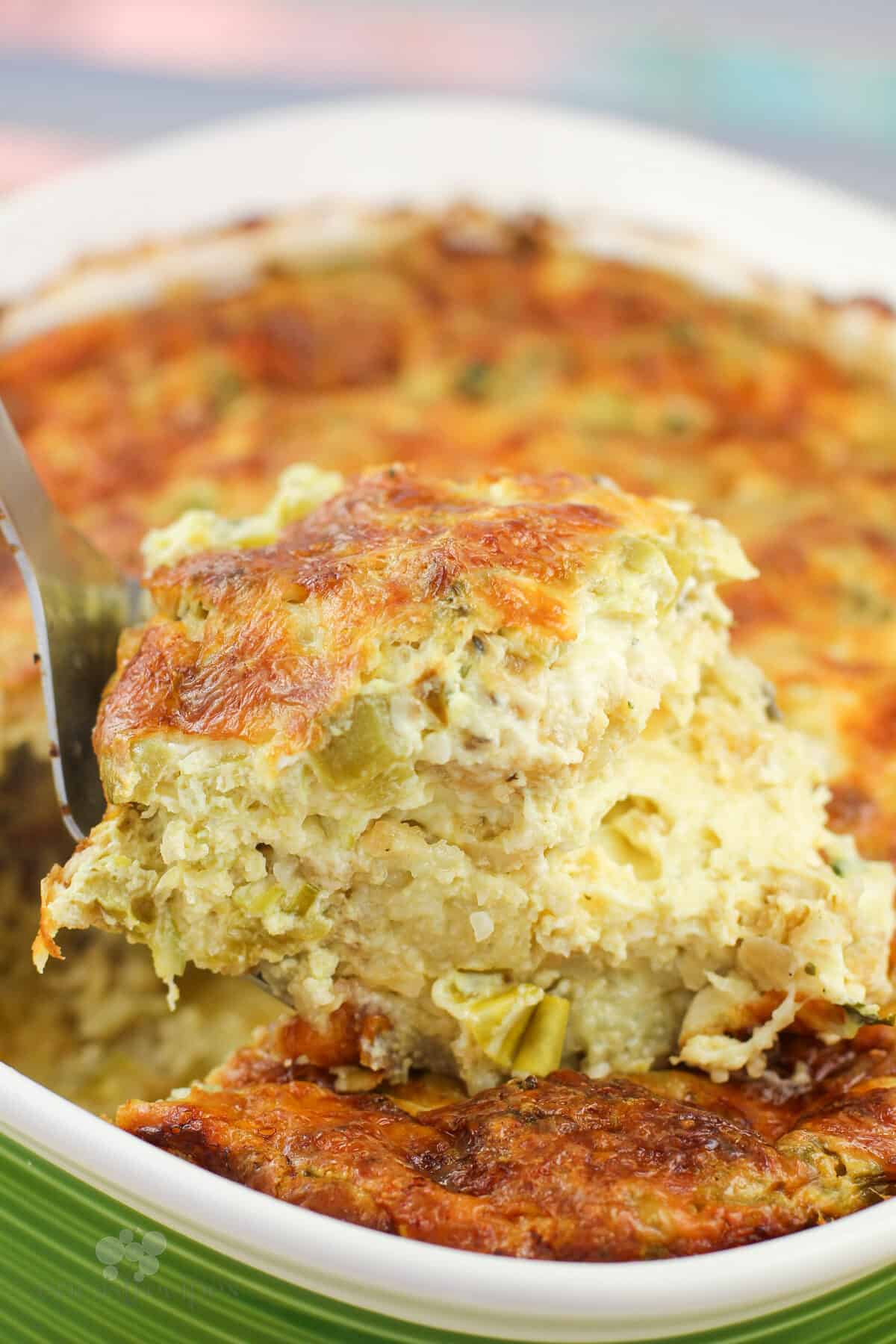 spatula holding serving of prepared casserole