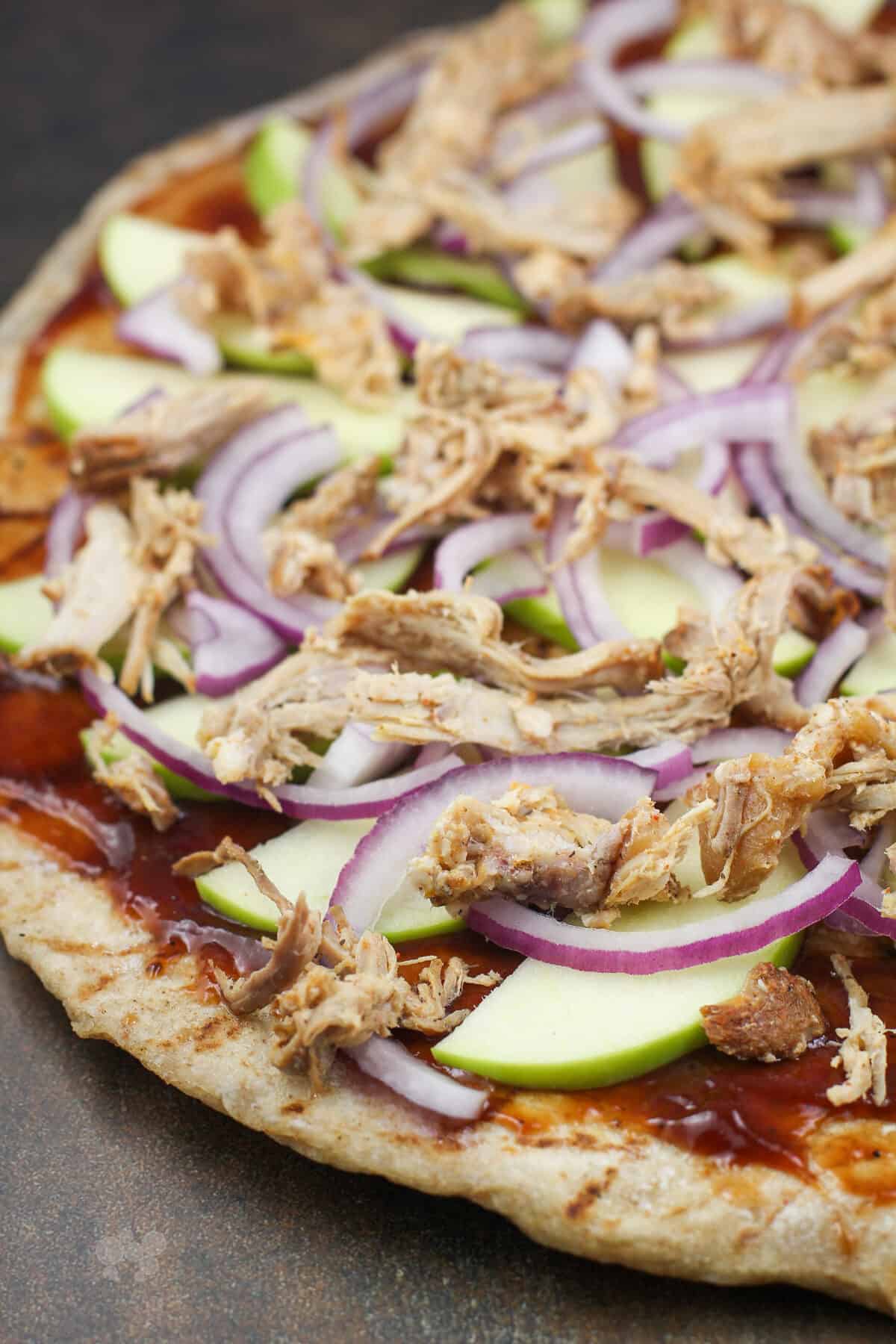 pizza toppings on crust before adding cheese.