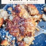 cooked garlic parmesan tater tots on black surface with spoon; text overlay recipe title for pinterest