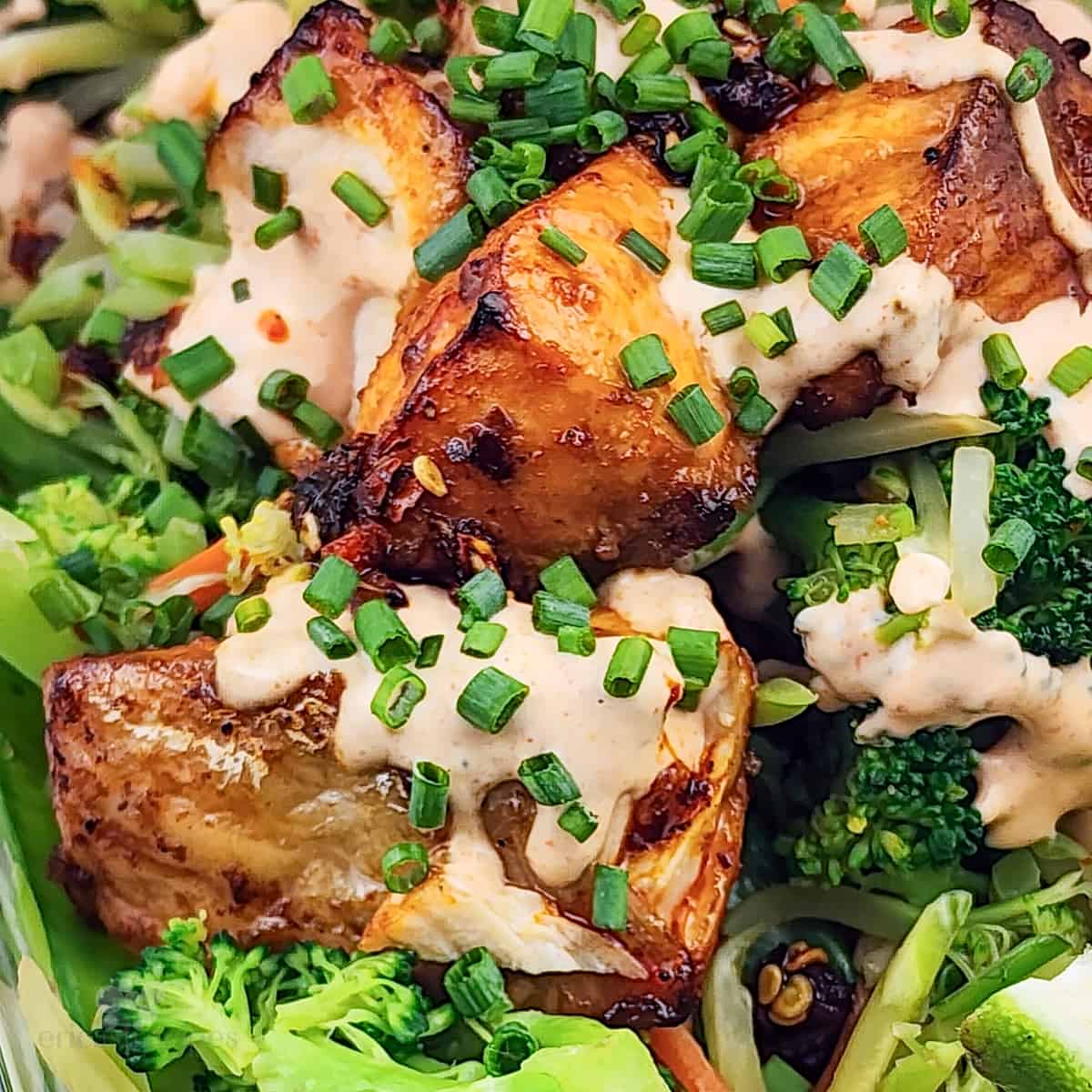 prepared firecracker salmon and vegetables, topped with chives