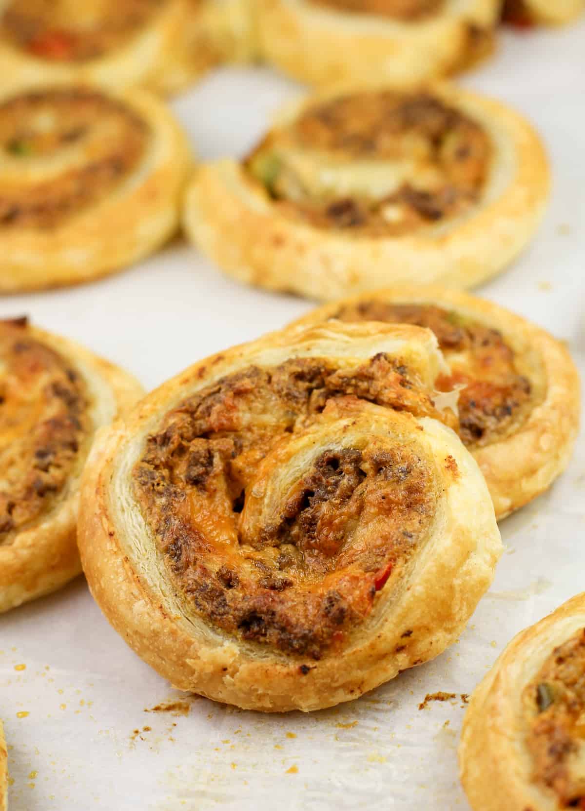 cooked taco pinwheels on parchment paper