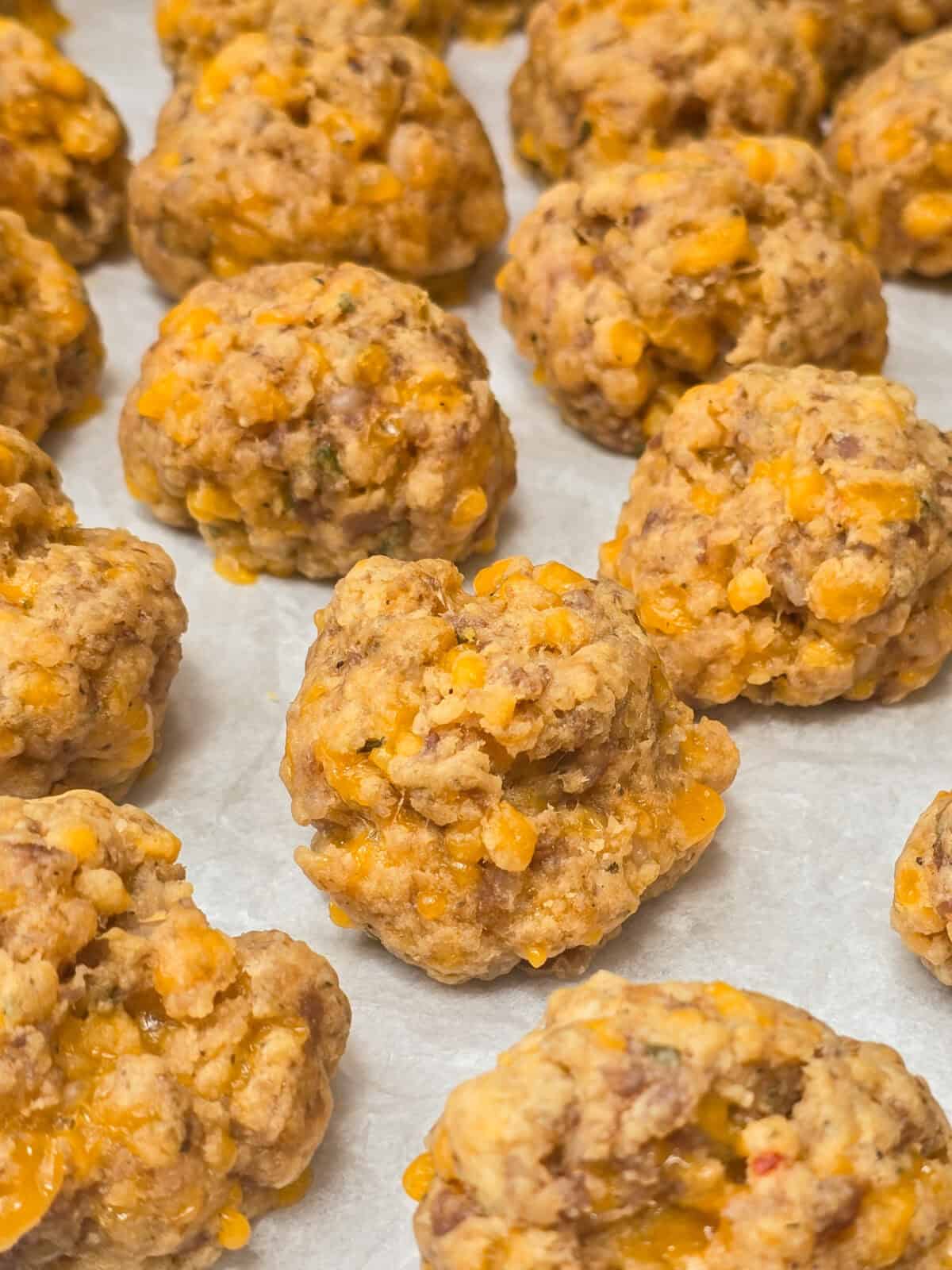 cooked sausage balls on parchment paper