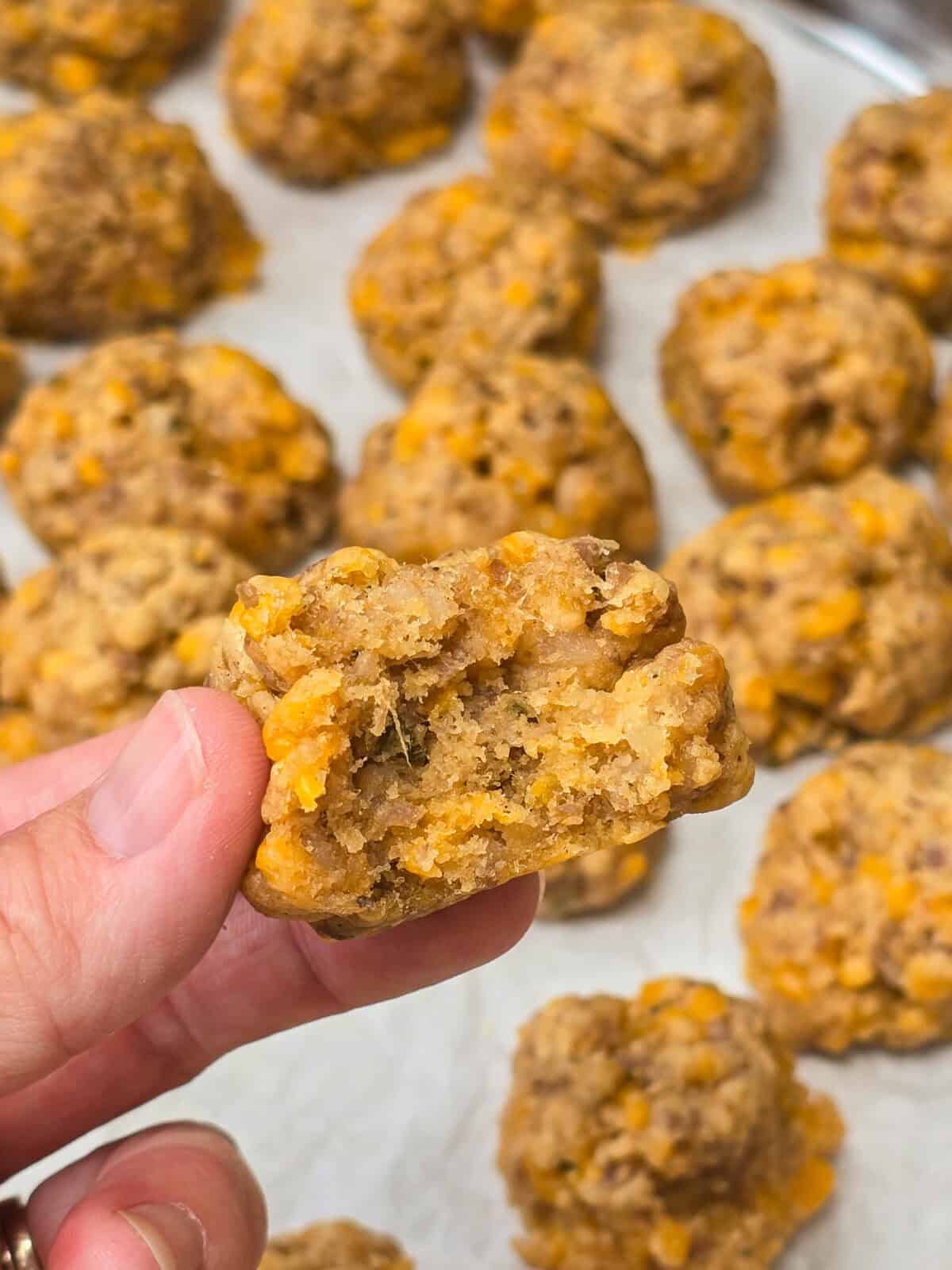 hand holding half a sausage ball to show inside